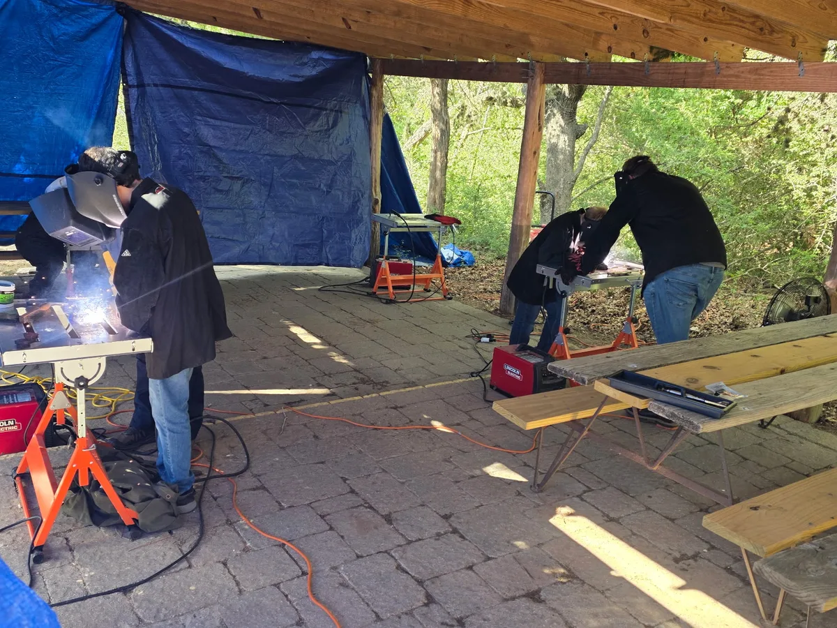 Dylan Martin of Alpha Construction teaching Scouts to weld at a STEM camp