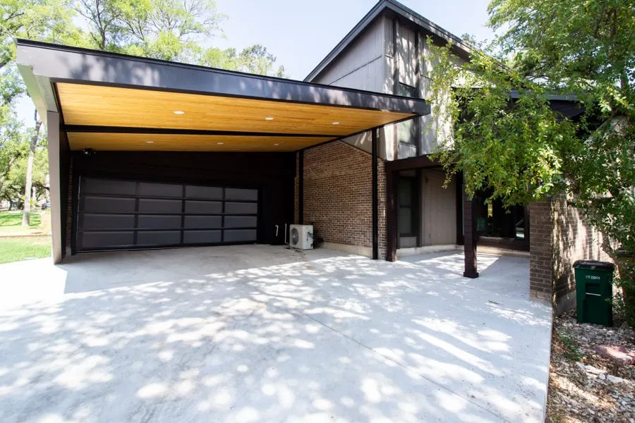 Modern custom home with cantilevered carport and wood soffit in Austin, TX