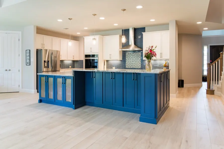 Completed kitchen remodel with navy island and granite counters in Austin, TX
