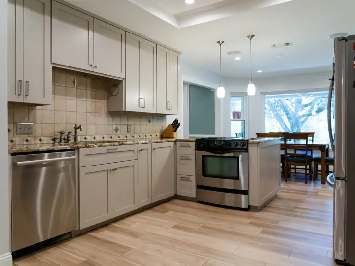Refreshed kitchen with new cabinet doors, hardware, and stainless appliances