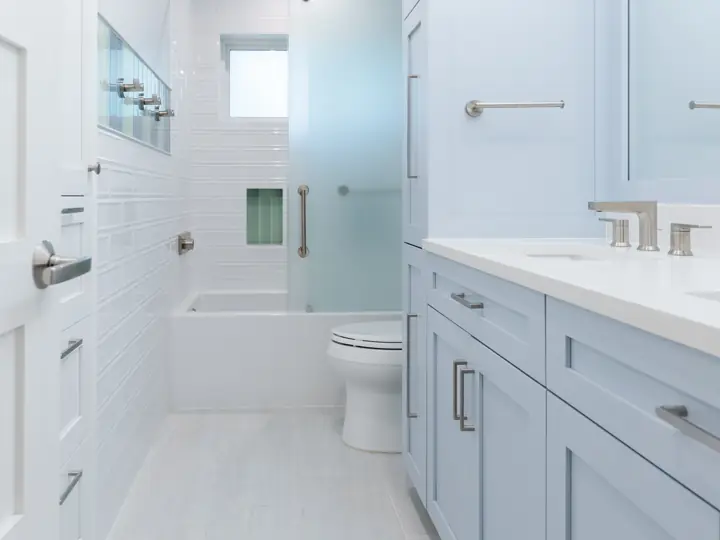 Kids bathroom remodel with floor-to-ceiling cabinetry and new vanity