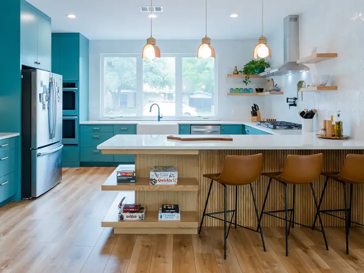 Teal cabinet kitchen with wood breakfast bar in a whole home remodel, Austin TX