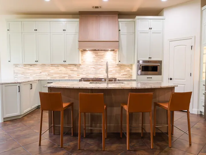 Lakeway kitchen remodel with large granite island and leather bar stools