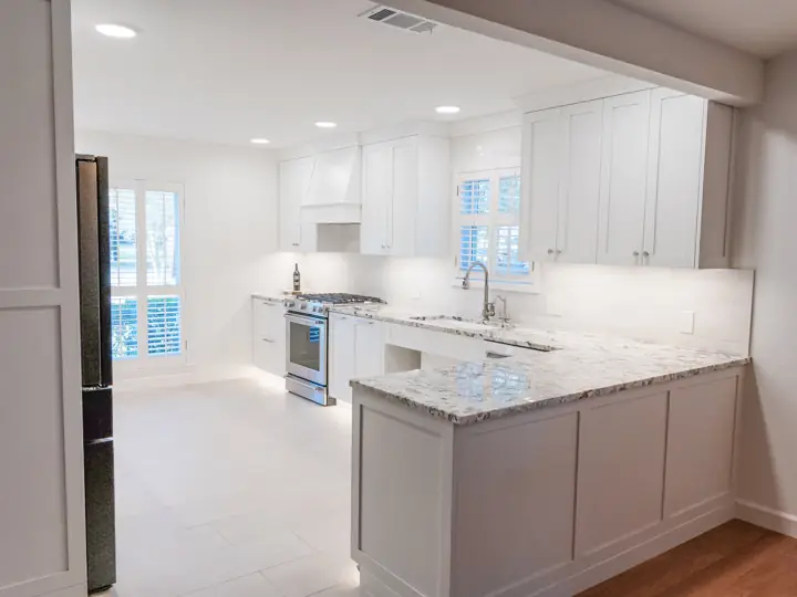 Accessible kitchen with roll-under sink and white cabinetry