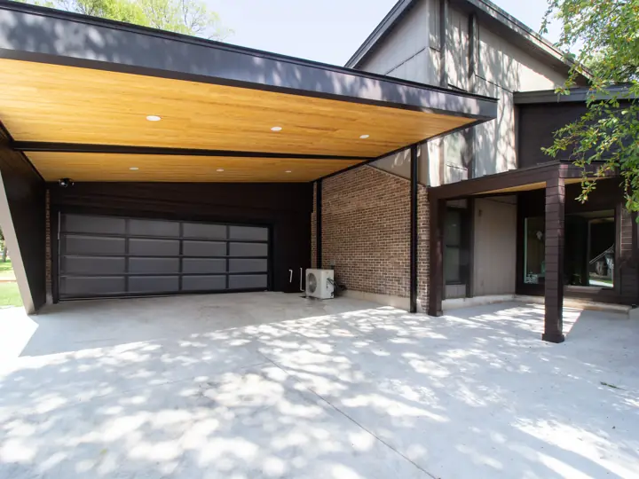Cantilevered carport with wood soffit on a modern home exterior