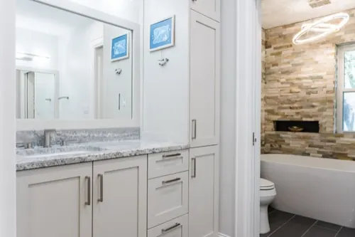 Bathroom remodel with freestanding tub and stacked-stone accent wall, Austin TX