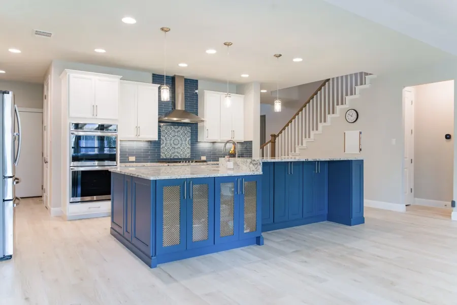 Kitchen remodel with navy blue island and granite counters, Austin TX