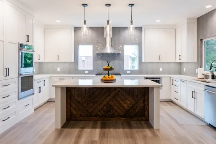 Remodeled kitchen with white shaker cabinets and wood-panel island in Austin, TX